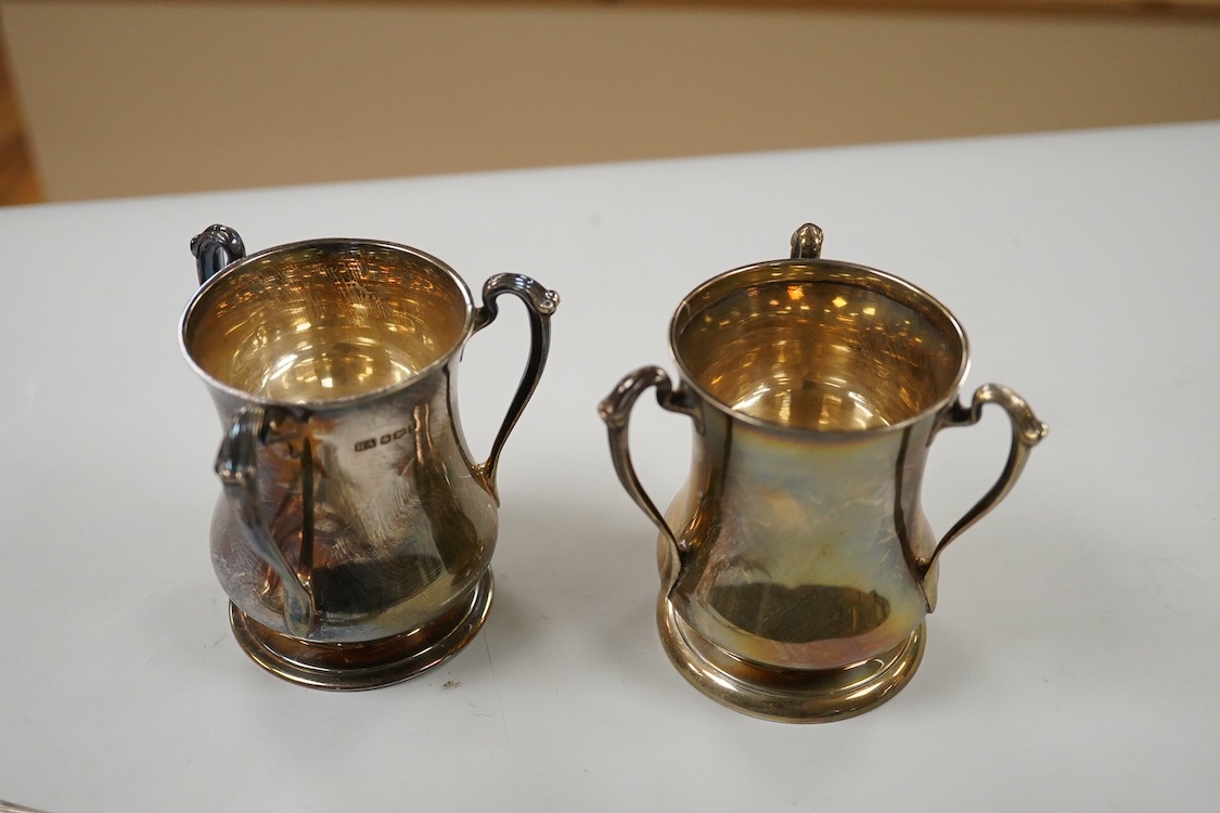 Two George V silver loving cups, one by Atkin Brothers, Sheffield, 1926, height 89mm and a set of four silver Hanoverian pattern dessert forks, Birmingham, 1930, 16.4oz.